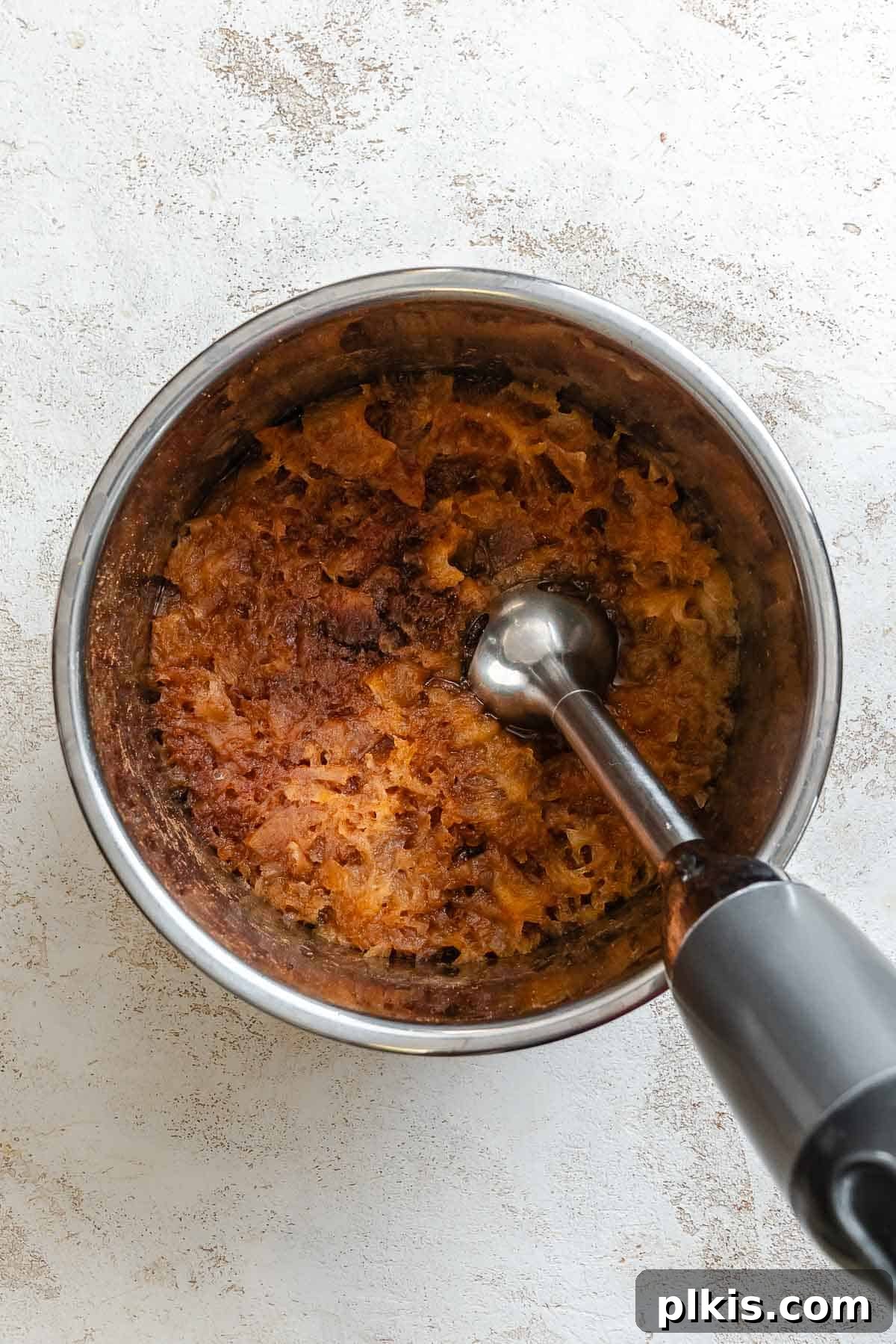 Process shot showing using immersion blender.