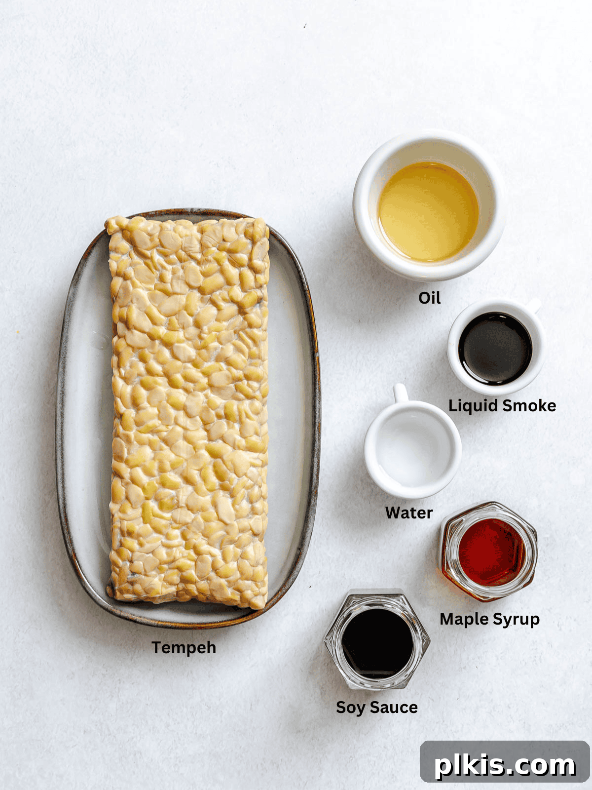 Ingredients for Tempeh Bacon measured out on a white surface.
