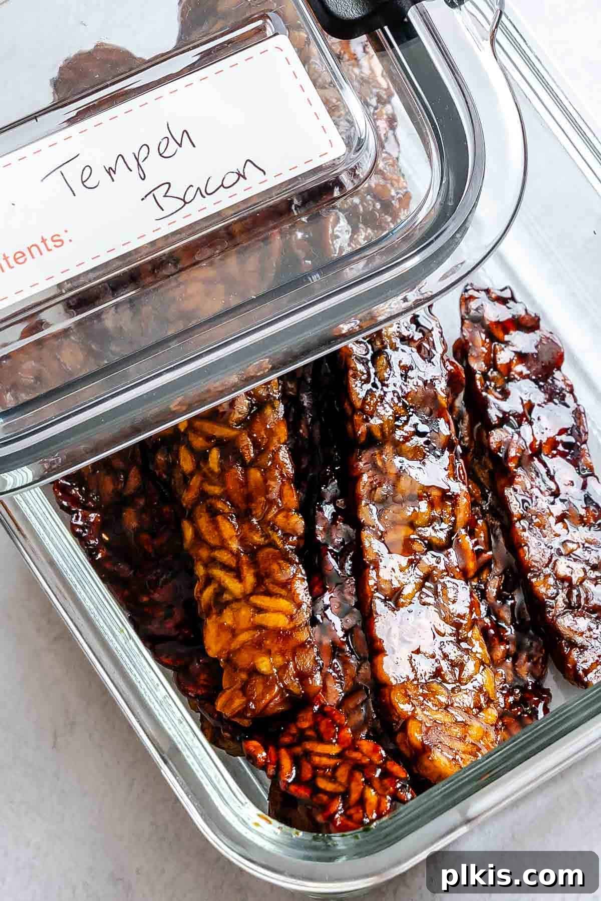 Completed Tempeh Bacon in a storage container.