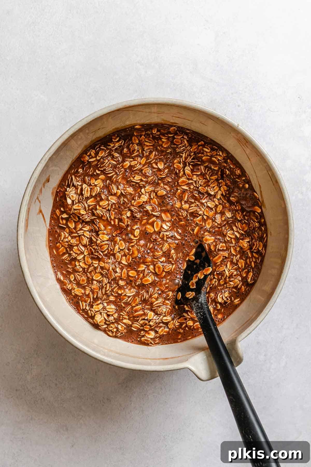 Chocolate Banana Baked Oatmeal with Peanut Butter Swirl 6 Process shot showing mixing ingredients in a bowl.