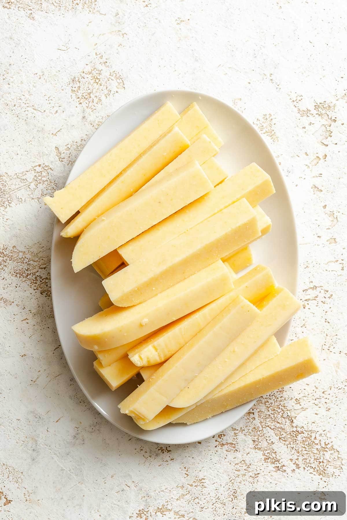 Process shot showing sliced polenta on a plate.