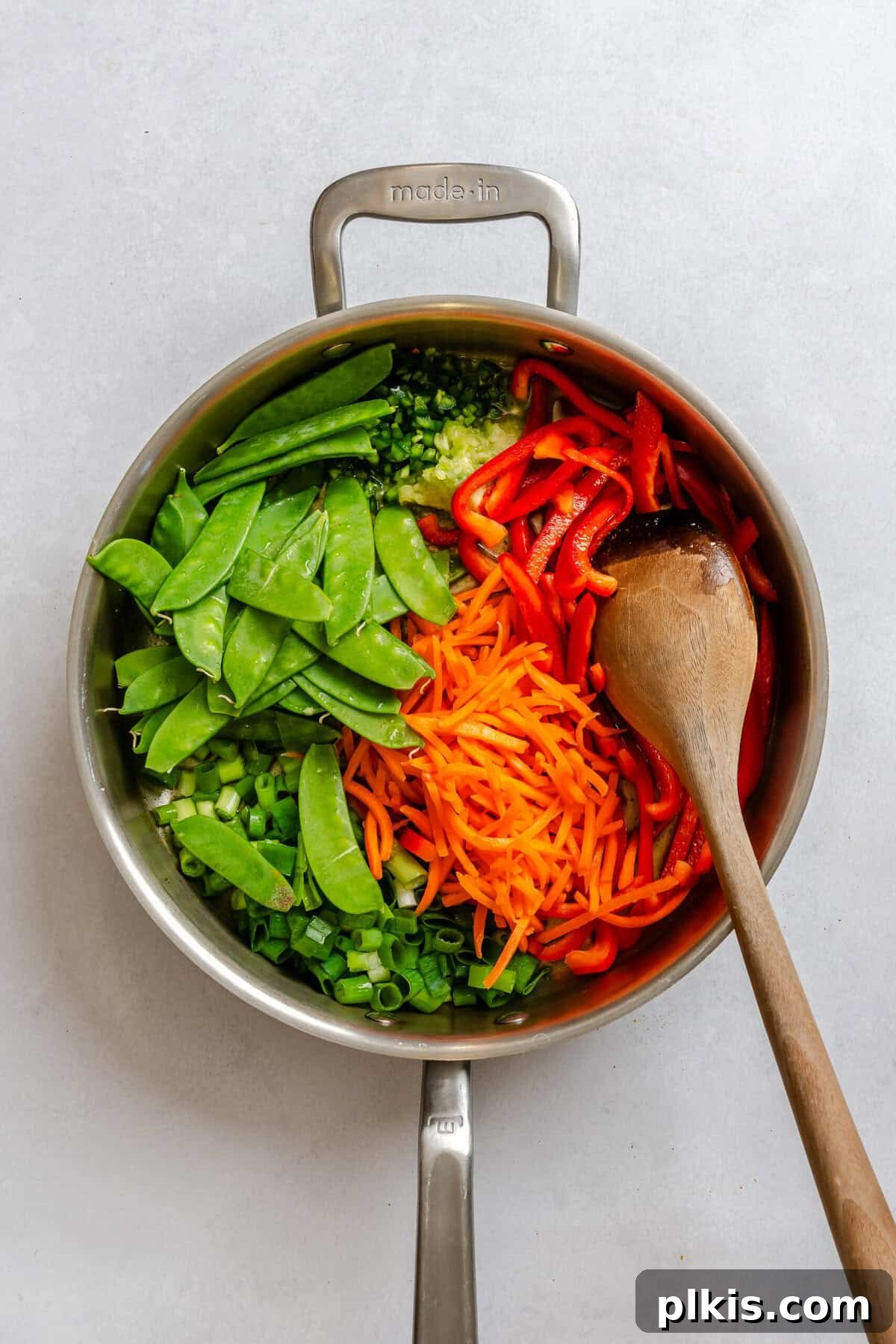 Process shot showing cooking ingredients in a pot.