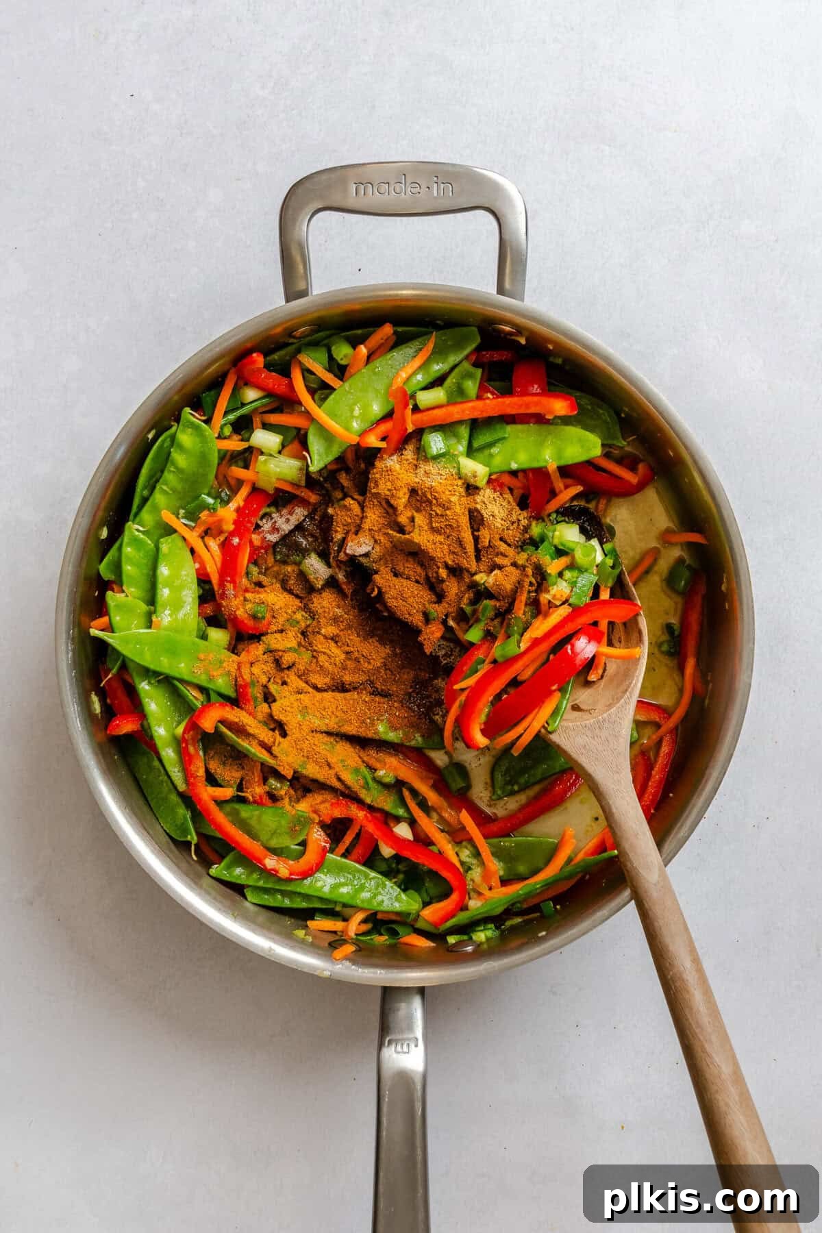 Process shot showing cooking ingredients in a pot.