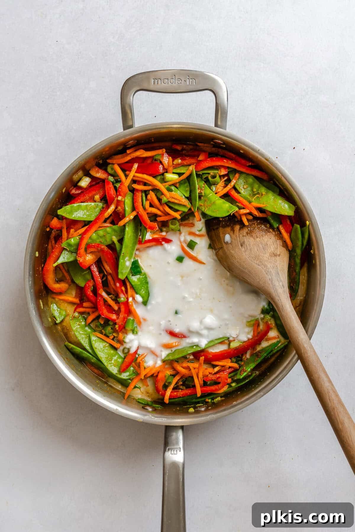 Process shot showing cooking ingredients in a pot.