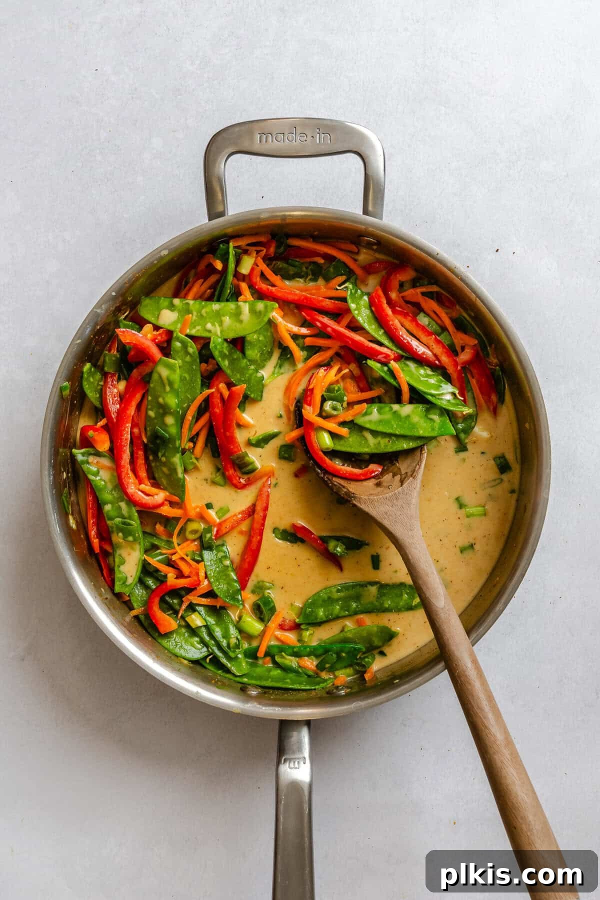 Process shot showing cooking ingredients in a pot.