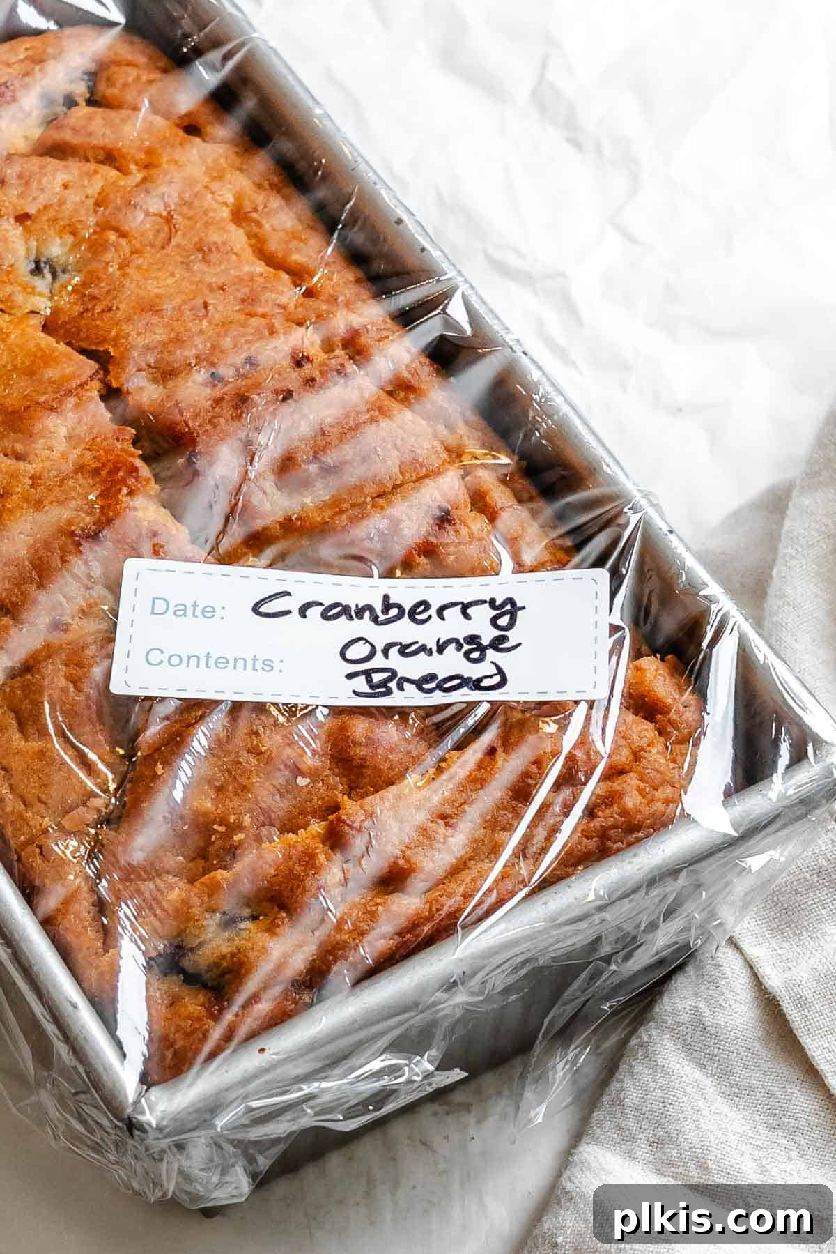 Eggless Cranberry Orange Bread Recipe 10 Completed Cranberry Orange Bread (Eggless!) in a storage container.