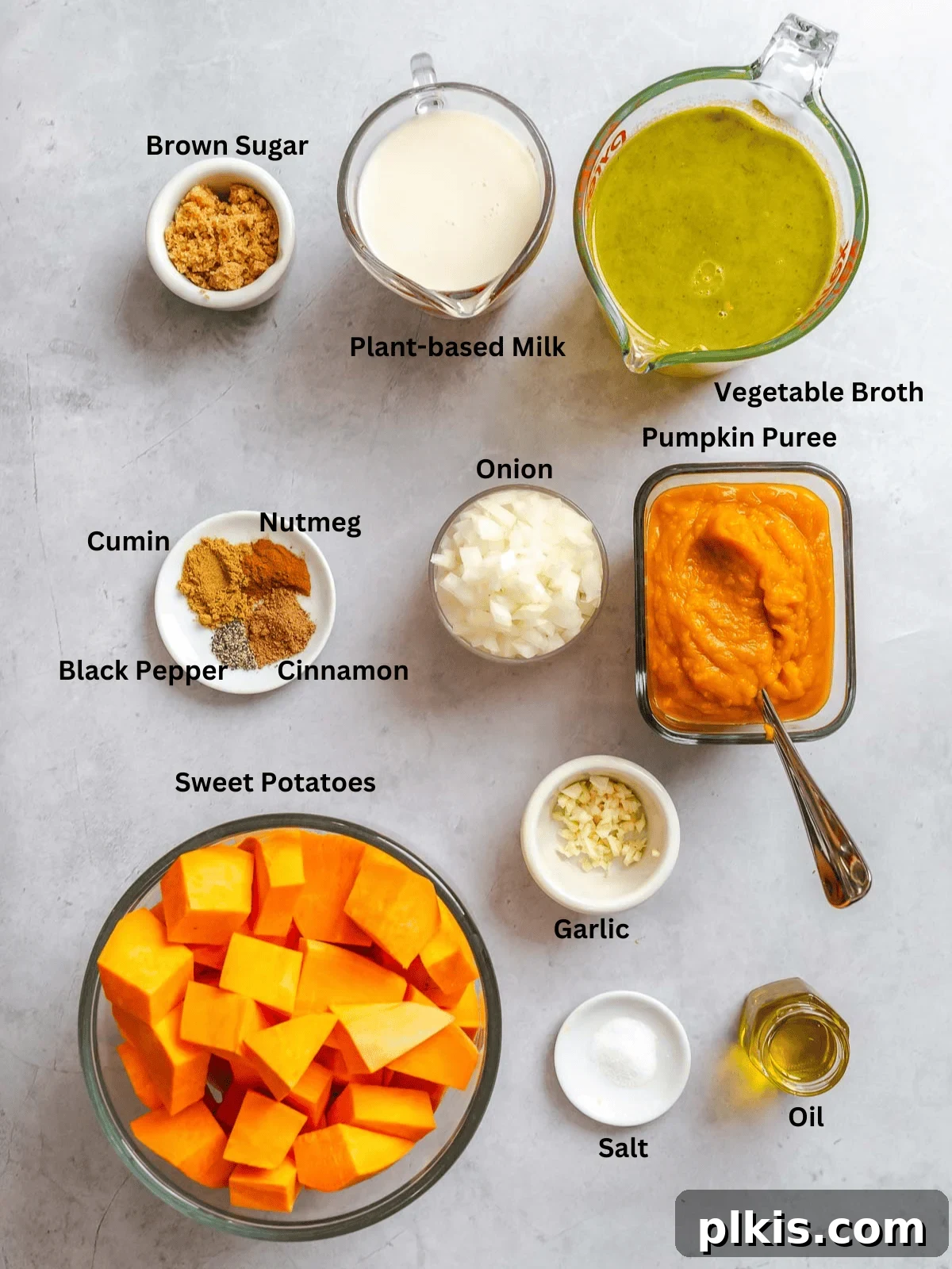 Ingredients for Sweet Potato Pumpkin Soup measured out on a white surface.