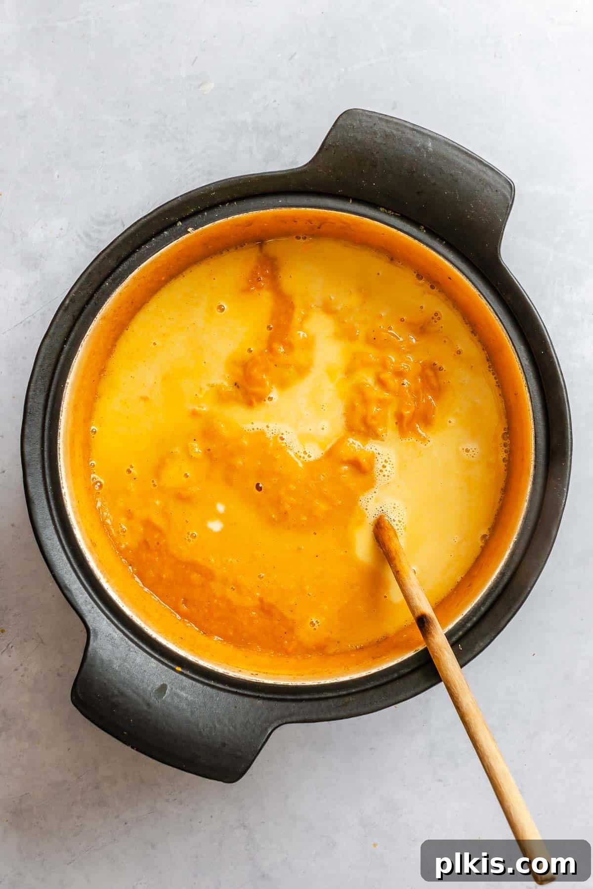 Process shot showing mixing ingredients in a bowl.