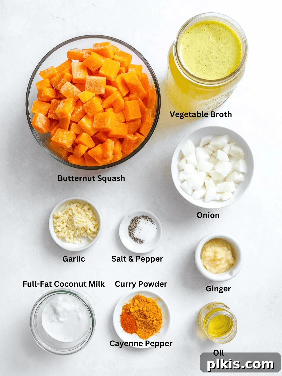 Creamy Curried Butternut Squash Soup 4 Ingredients for Curried Butternut Squash Soup measured out on a white surface.