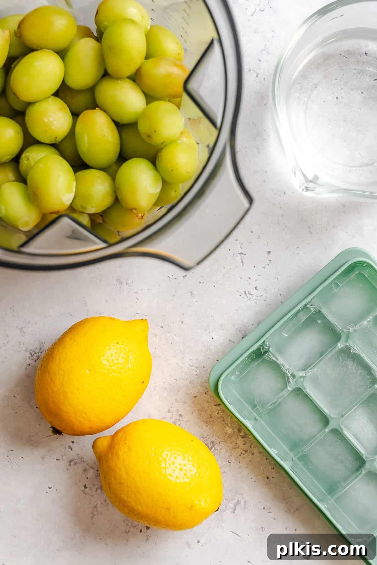 California Grape Lemonade Slushie Recipe for Summer 4 Ingredients for Grape Lemonade Slushie measured out on a white surface.